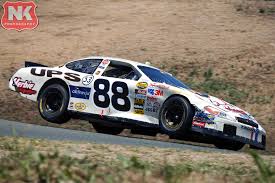 The remnants of the Bill Elliott/Dan Marino Ford Taurus heads to pit road  after an incident at Watkins Glen during the 1998 Bud at the Glen. Driven  by Tom Hubert
