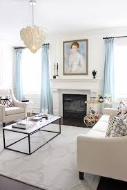 Exquisite Living Room In White With Light Blue Drapes And French Finesse Curtains Living Room White Living Room Decor Blue Living Room