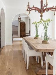 With clean lines and a rustic finish, this dining table is the perfect anchor for your dining room. Bright Transitional Dining Room Featuring Antique Chandelier And Natural Wood Dining Table Hgtv