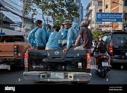 Workers traveling home on a fully loaded pickup truck. Thailand Stock Photo  - Alamy