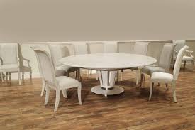 This rectangular dining table is crafted from a blend of solid poplar wood and veneers, and showcases a distressed white finish for a rustic touch. Sarreid Jupe Dining Table In White Pigmented Oak Finish Soho