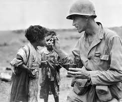 An American serviceman shares his rations with two Japanese children in  Okinawa, 1945. Most of good people just cared about human not race or  country. This man needs appreciation