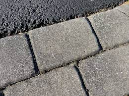 Edging makes an asphalt driveway look better and last longer. Belgian Block And Pavers Dressing Up An Asphalt Driveway All About The House