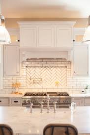 Glazed Brick Backsplash With Herringbone Pattern Pot Filler Niche By Rafterhouse Trendy Kitchen Backsplash Rustic Kitchen Kitchen Remodel