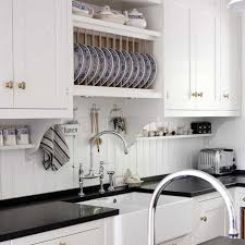 Kvanum Crisp White Kitchen With Black Quartz Countertops Beadboard Backsplash Beadboard Kitchen Black Quartz Kitchen Countertops Diy Kitchen Backsplash