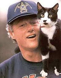 A black and white cat named socks, and a chocolate labrador retriever named buddy. President Bill Clinton