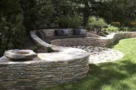Next, carry the bench or its pieces to the designated location. Stone Seating And Decking Backyard Backyard Landscaping Dry Stone Wall
