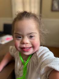 Meet Lottie. This sweet little girl is full of personality, and you can  tell that she is always so happy. Lottie lives with down syndrome, but just  a few months ago, her