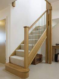 The runner creates neat, tailored lines on the stairs and looks gorgeous alongside chocolate floors and railings accented by classic, ivory banisters. Timber Staircases Oak Stairs Salisbury Joinery