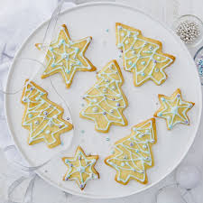 These are round cookies sandwiched with jam and topped off with a delicious icing and a cherry. Baking Christmas Shortbread Biscuits To Eat Or Gift
