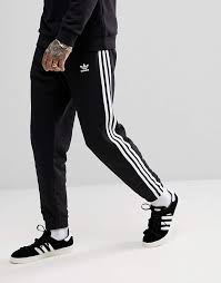 Adidas Originals Three Stripe Cuffed Sweatpants In Black Adidas Adicolor 3 Stripe Joggers In Black Cw2981 Sneakers Men Fashion Adidas Originals Fashion How To Wear Joggers