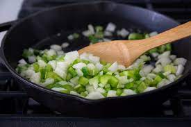 These ingredients are typically sauteed . The Cajun Holy Trinity National Onion Association