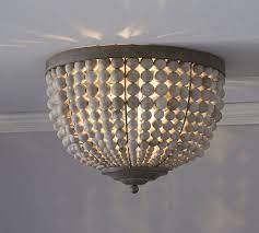 This chandelier works beautifully in dining room, living room,foyer and bedroom spaces. Leila Wood Bead Flush Mount Pottery Barn