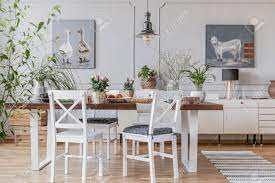 Q&s rustic farmhouse ceiling light fixture flush mount,vintage ceiling lights,white ceiling lights for hallway entryway kitchen dining room bedroom,wrought iron oak white and orb finish,1 light e26 4.4 out of 5 stars 357 White Chairs At Table With Flowers In Rustic Dining Room Interior With Lamp And Posters Real Photo Stock Photo Picture And Royalty Free Image Image 108252273