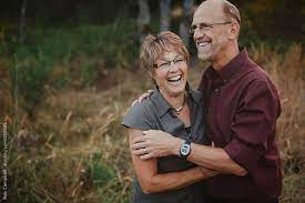 Middle Aged Couple In Mid Fifties Having Fun Holding Each Other Laughing By Rob Campbell Couples Middle Aged Couples Photography Middle Age Couple