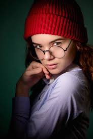Ginger woman wearing glasses and green hat pouting her lips ready for kiss  — Stock Photo © ufabizphoto #181011968