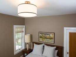 To avoid straining the connections, temporarily hang the new fixture from the box with the bent coat hanger. How To Change A Light Fixture Hgtv