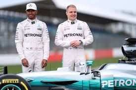 A day later, that wheel is still there. Lewis Hamilton And Valtteri Bottas Pose By Mercedes F1 Car Abc News Australian Broadcasting Corporation