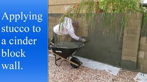 A leveling coat of plaster applied to the wall prior to the color coat prevents the grout lines from shadowing through the color coat. Applying Stucco To A Cinder Block Wall Youtube