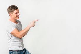 Free Photo | Side view of a smiling young man pointing her finger at  something against white background