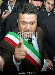 ** FILE ** Mayor of Scanzano Jonico Mario Altieri, center, gestures during  a press conference in Scanzano Jonico, near Matera, Southern, Italy, in  this Saturday, Nov. 22, 2003 file photo, after an area close to the village  was chosen as a possible site for the ...