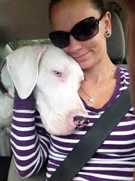 Blind and deaf Opal isn't sure what the car window is, but she knows she  likes it!