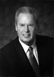 Coach Bill Stewart speaks to the last graduating class of the School of  Physical Education at the 2008 May Commencement ceremoni