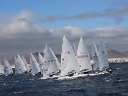 The laser radial is a variant of the laser standard, with shorter mast and reduced sail area, allowing light sailors to sail in heavy winds. Sailing News Laser Radial Standard Olympic Winter Series Lanzarote Esp Day 1