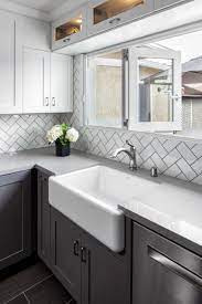 Remodeled Kitchen Complete With White Subway Tile Backsplash In Herringbone Pattern White Shaker Kitchen White Shaker Kitchen Cabinets Gray And White Kitchen