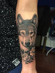 Realistic Wolf And Peony Tattoo On A Woman Lower Arm Beautiful In 2020 Peonies Tattoo Wolf Tattoos Wolf Tattoos For Women