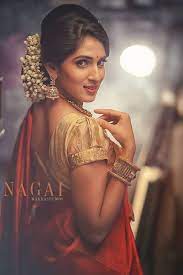 South Indian Bride Temple Jewelry Jhumkis Red Silk Sari Bun With Fresh Jasmine Flowers Tamil Indian Bridal Hairstyles Indian Hairstyles Indian Bridal Makeup