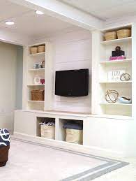 Custom cabinets create stylish storage. Diy Built In Media Wall Unit With Extra Storage From An Ikea Bookcase Remodelaholic Diy Wall Unit Wall Unit Media Wall Unit