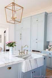 Sweet Pastel Blue Cabinets And Marble Farmhouse Sink Accessorize With Everything Golden In Colour Home House Design Home Decor