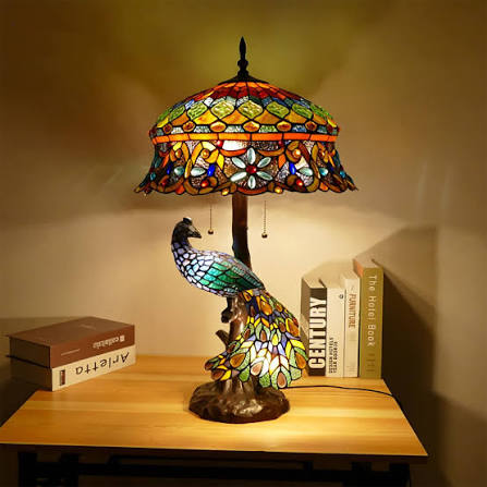 The “Wisteria” Table Lamp by Tiffany Studios New York: This unusually rare lamp is composed of a palette of wisteria blossoms in shades of blue, green, cream and white that cascade down