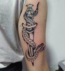 Get all your favorite things on your thigh with a perfectly get this snake tattoo design with some geometrical designs in the background. Top 30 Dagger Tattoos Trending Dagger Tattoo Designs Ideas