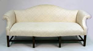 Nicely shaped chippendale style camelback sofa, scooped back scrolled arms, mahogany base with straight legs and stretchers, chinese fretwork brackets irish walnut camelback sofa in georgian chippendale styling. A Chippendale Style Camelback Sofa