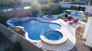 Deck jets are curving streams of water that arise from the edge of the pool and arc into the water. New Pool With Deck Jets Arizona S Leading New Pool Builder Backyard Remodeler