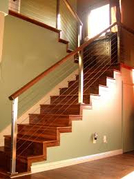 Railing poles can be spaced close together for safety's sake or spaced wide apart for a less intrusive look. Stainless Steel Staircase Cable Railing With Wood Handrails