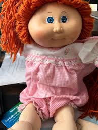 1978-1982 pre-owned doll for sale, boasting blue eyes, orange yarn hair,  and a distinctive green signature from Xavier Robert, offered at $30.00,  with shipping responsibilities resting with the buyer, photos available for