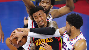 Hawks forward john collins dunks on 76ers center joel embiid during game 6 of the second round on june 18, 2021. 1ekgmhs Le4tkm