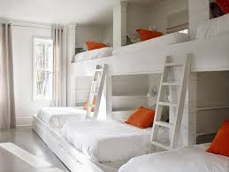 A bed bunk divider was the solution for this family! Country Bunk Room Features A Shiplap Walls Lined With A Wall Of Three Side By Side Built In Bunk Beds Dressed Bunk Bed Rooms Bunk Beds Built In Sleepover Room