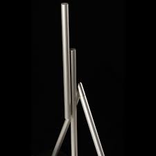 It's a simple top with magnetic tips, that roll along two tin plates. The Swinging Sticks Kinetic Desk Sculpture