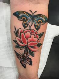 For example, christians consider these winged creatures as a extremely feminine and chic, these butterfly and flower tattoos will definitely showcase your fun personality. Traditional Flower With Two Flying Butterflies Tattoo On Forearm