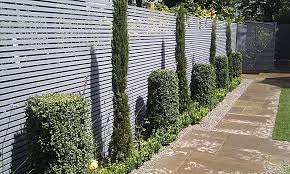 Whether the design is wood or metal, a garden trellis creates a beautiful backdrop for outdoor living spaces. Garden Fence Ideas Backyard Fences Fence Landscaping Garden Fence