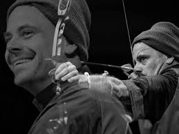 Who is the musician in the blue light shot?