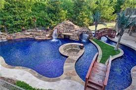 Natural island style #pools #poolwaterfall. Large Pool Island Style Pool Houses Backyard Pool Designs Swimming Pools Backyard