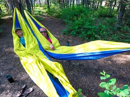 Wrap a tree strap around one of the trees you found and pass the metal ring through the loop. 21 Expert Hammock Camping Tips To Keep You Comfy All Night