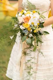 Simple ribbons puddling to the floor served as aisle decor. Yellow Peach Light Blue Vintage Travel Wedding Inspiration Chicago Style Weddings
