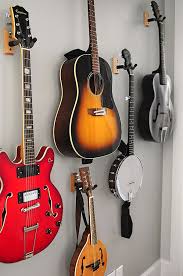 This Guitar Wall Is An Example Of A Simple And Functional Way To Display Instruments Guitar Wall Music Room Living Room Storage
