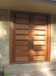 Also visible is a large garage door through which a car can enter into the garage. Elegant Front Entry Double Doors